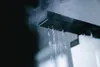 Close-up of a shower head with water and steam coming out. Produktbild-Vorschau