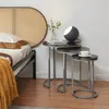 A bedroom scene with a bed, a headboard, and nesting tables. Anteprima dell’immagine prodotto