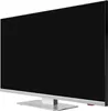 A side view of a modern flat-screen television on a silver stand. Produktbild-Vorschau