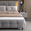 A bedroom scene featuring a bed with a headboard and nightstand. Náhľad obrázku produktu