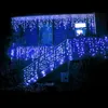 A house decorated with blue icicle lights at night. Produktbild-Vorschau