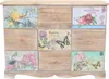 A wooden chest of drawers with decorative panels on each drawer. Produktbild-Vorschau