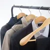 Clothing items on hangers on a rack. Produktbild-Vorschau