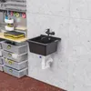 A utility sink and storage bins in a workshop or garage setting. Anteprima dell’immagine prodotto