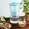 A water filter pitcher with a glass of lemon water and food on a wooden table. Náhľad obrázku produktu