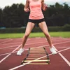 A person is training on a running track with an agility ladder. Náhled obrázku produktu