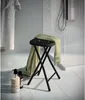 A bathroom scene with a stool, towel, and toiletries. Anteprima dell’immagine prodotto