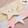 A wooden star-shaped night light with a cute face is placed on a wooden surface, surrounded by a garland of pink and light blue felt triangles. Náhled obrázku produktu
