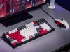 A gaming keyboard and mouse are set up on a desk next to a computer monitor. Produktbild-Vorschau