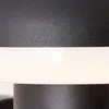 A close-up view of a black outdoor wall lamp with a white illuminated band. Produktbild-Vorschau