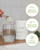 A hand is shown adding powder from a spoon into a glass of water, next to a product container. Informational circles with icons and text are on the right side. Produktbild-Vorschau