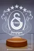 A 3D LED lamp with the Galatasaray logo and the word 'Şampiyon' (Champion) on a wooden base. Produktbild-Vorschau
