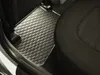 A close-up view of a car's interior, showing a black rubber floor mat with a hexagonal pattern. Produktbild-Vorschau