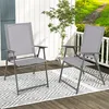 Two gray folding chairs are set up on a wooden deck with a patterned rug underneath. Produktbild-Vorschau
