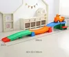 A child's toy race track with a car on it, set up in a room with storage units and decorations. Voir les images du produit
