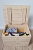 An open wooden chest filled with folded textiles. Náhled obrázku produktu