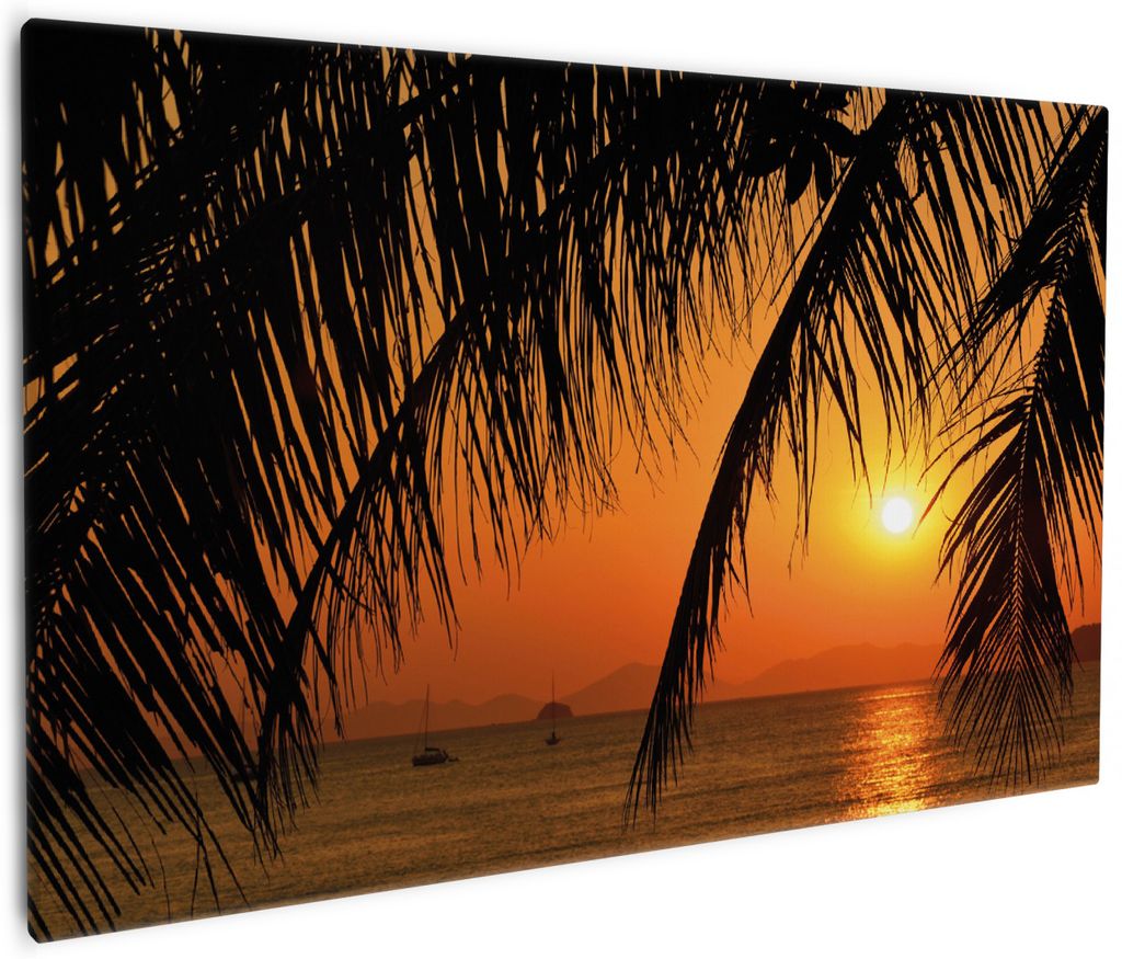 Wallario Premium Leinwandbild Sonnenuntergang unter Palmenblättern in Größe 60 x 90 cm