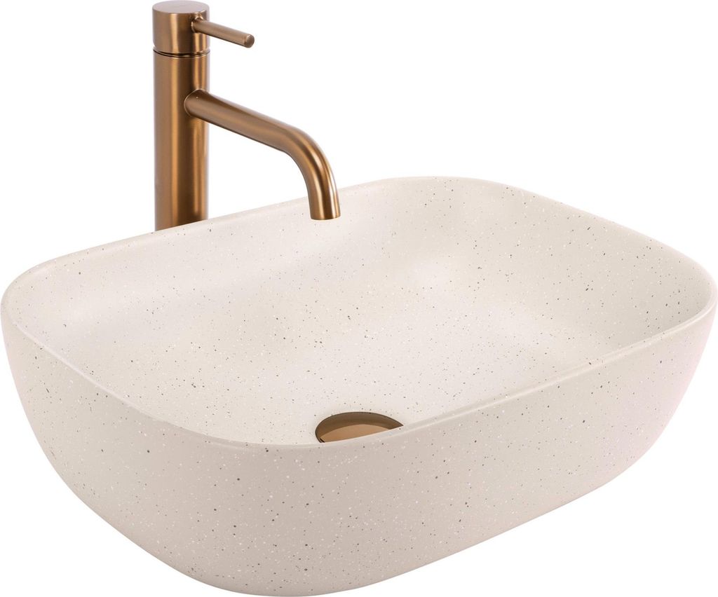 A beige countertop sink with a gold faucet.