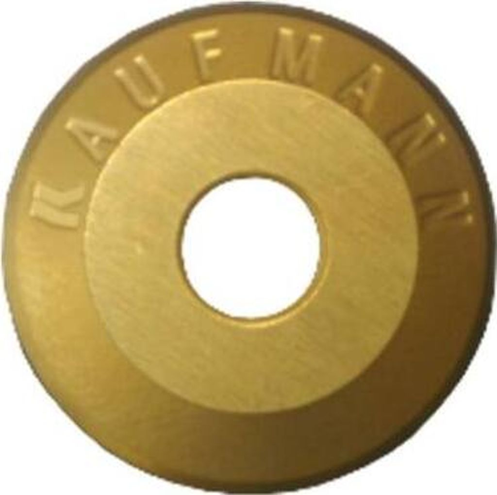 A close-up, centered shot of a gold-colored circular metal disc with a hole in the middle.