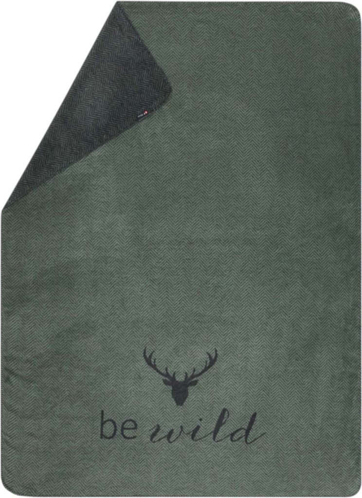 A green blanket with a deer head graphic and the text 'be wild'.