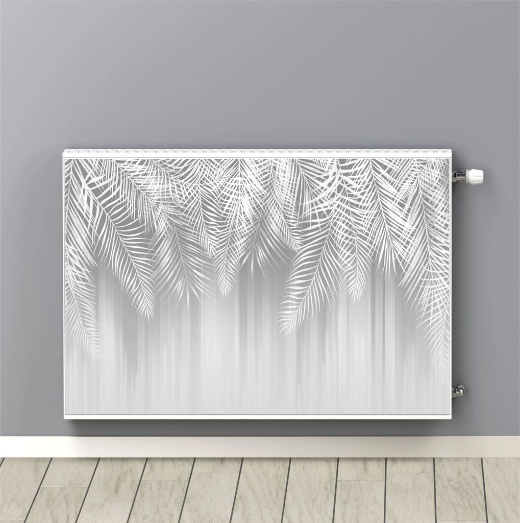 A radiator cover with a white leaf pattern is shown mounted on a gray wall above a wooden floor.