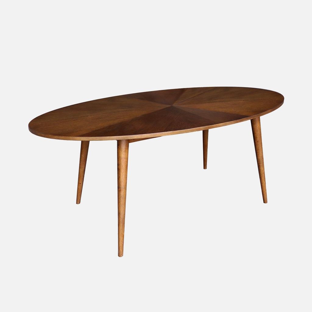 An oval wooden dining table with four legs, set against a white background.