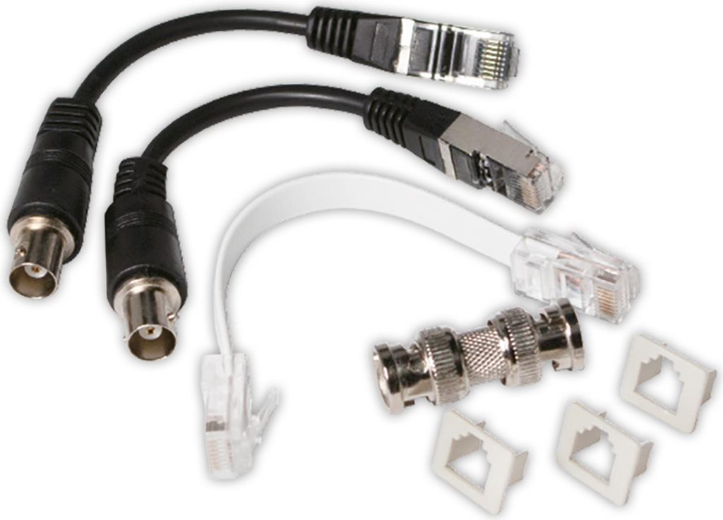 A collection of network cables and adapters, including BNC to Ethernet adapters and Ethernet cables.