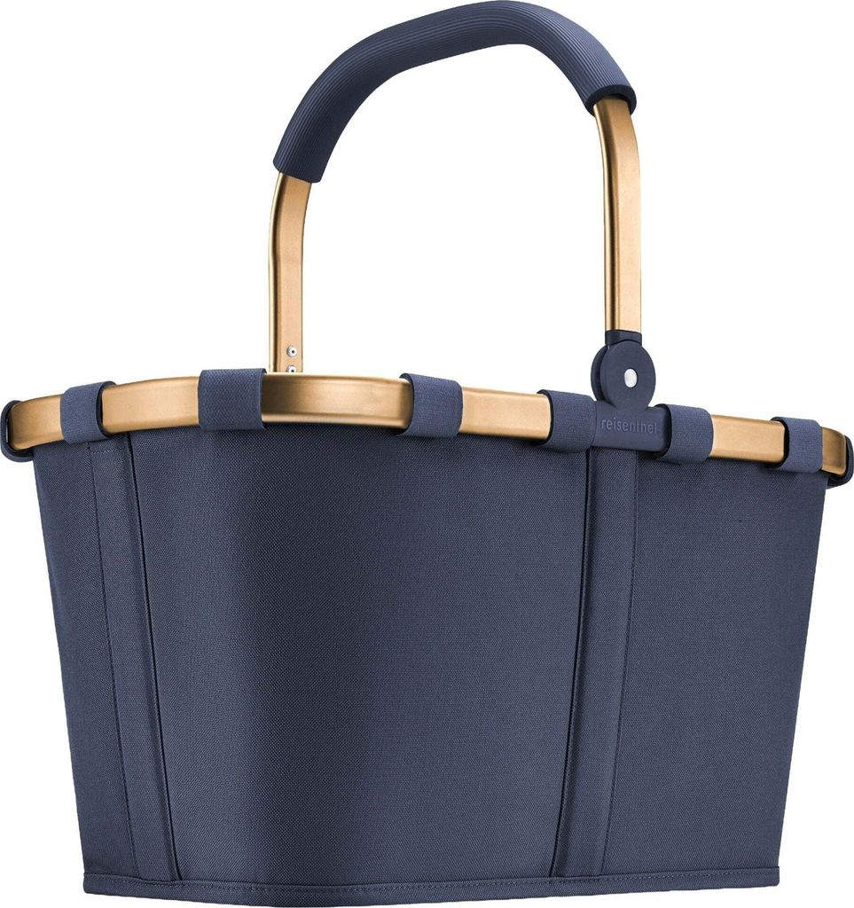 A studio shot of a blue reisenthel carrybag with gold accents.
