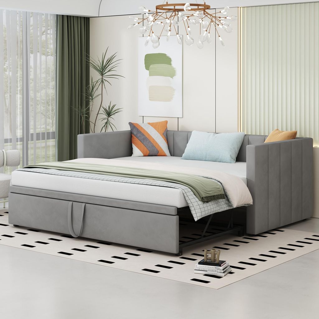 A light gray sofa bed is shown in a well-lit room with modern decor.