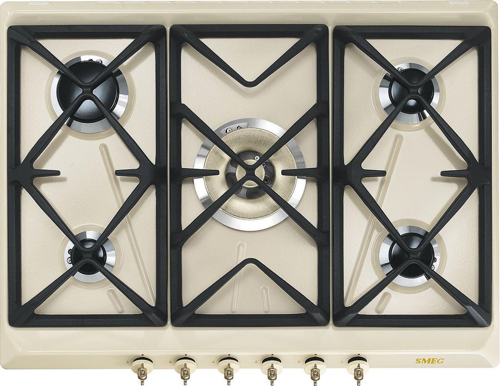A top-down view of a cream-colored gas hob with black grates and silver burner caps.