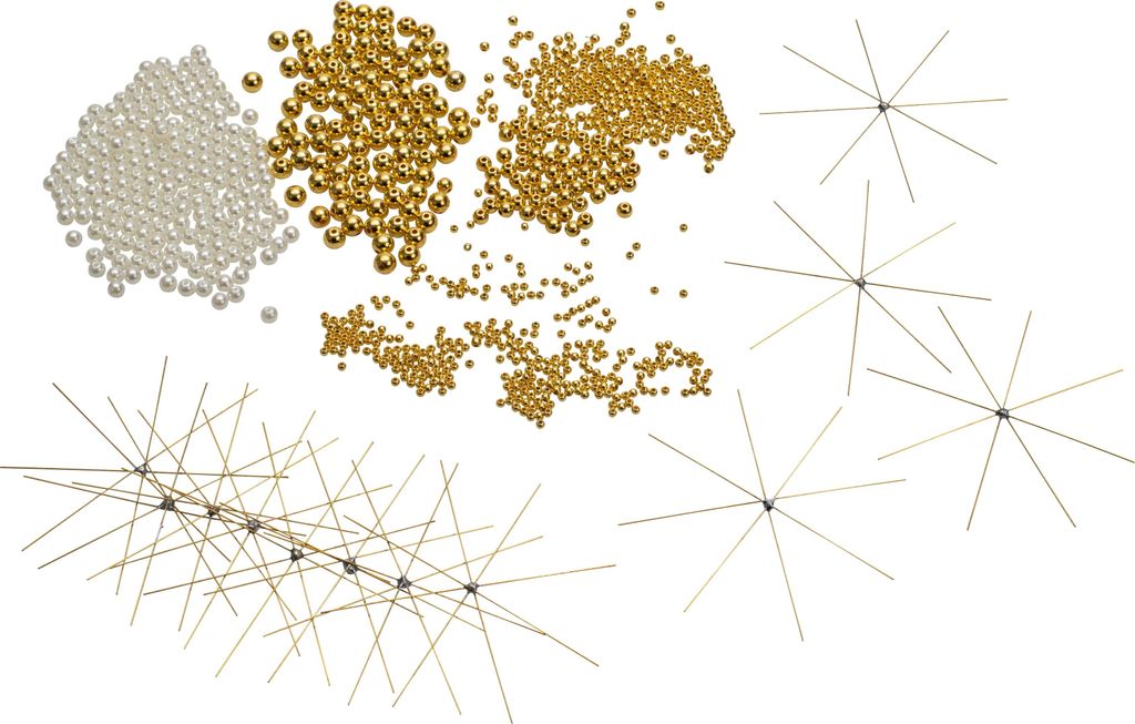 A collection of gold and white beads and several wire starburst decorations.