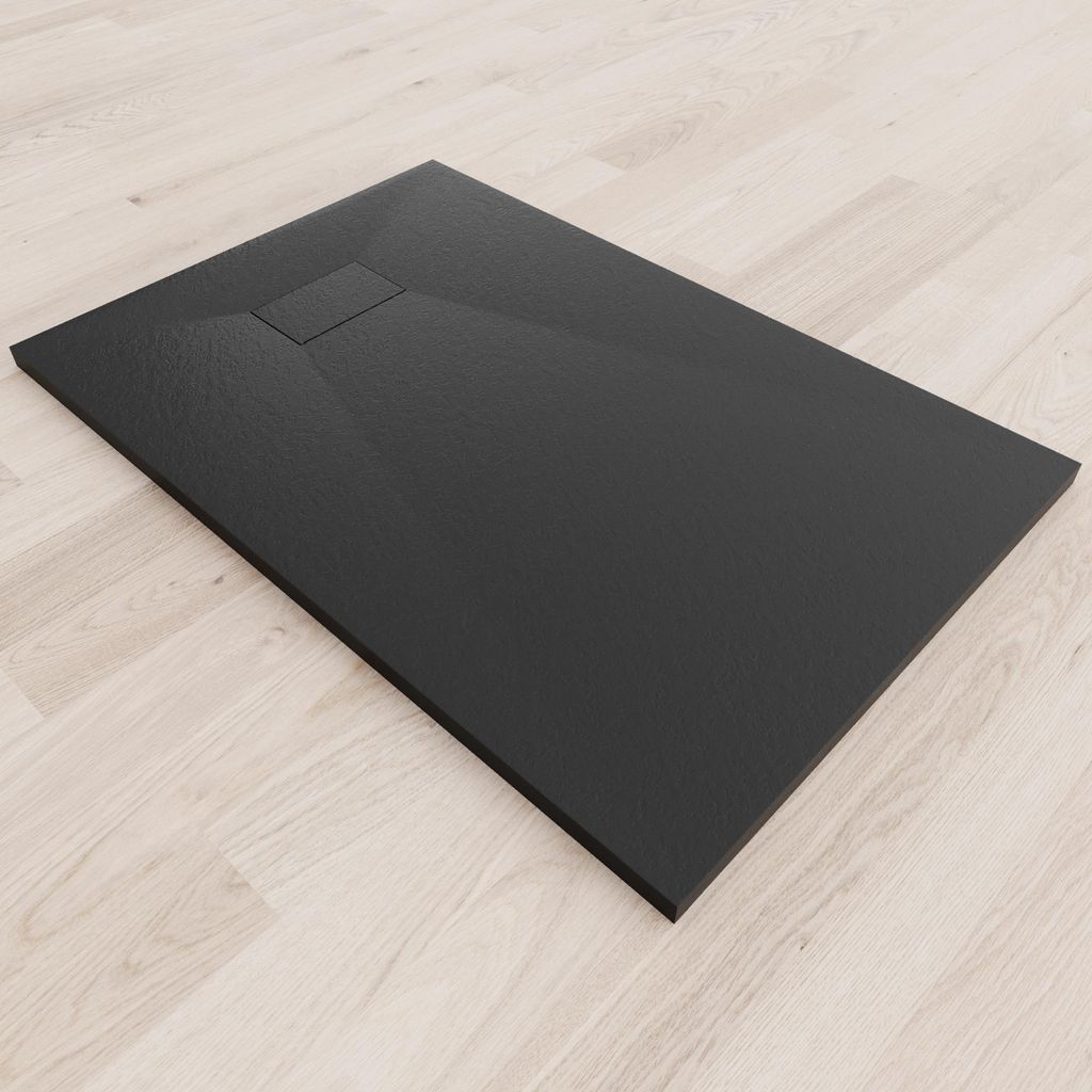 A black shower tray with a textured surface is placed on a light wooden floor.