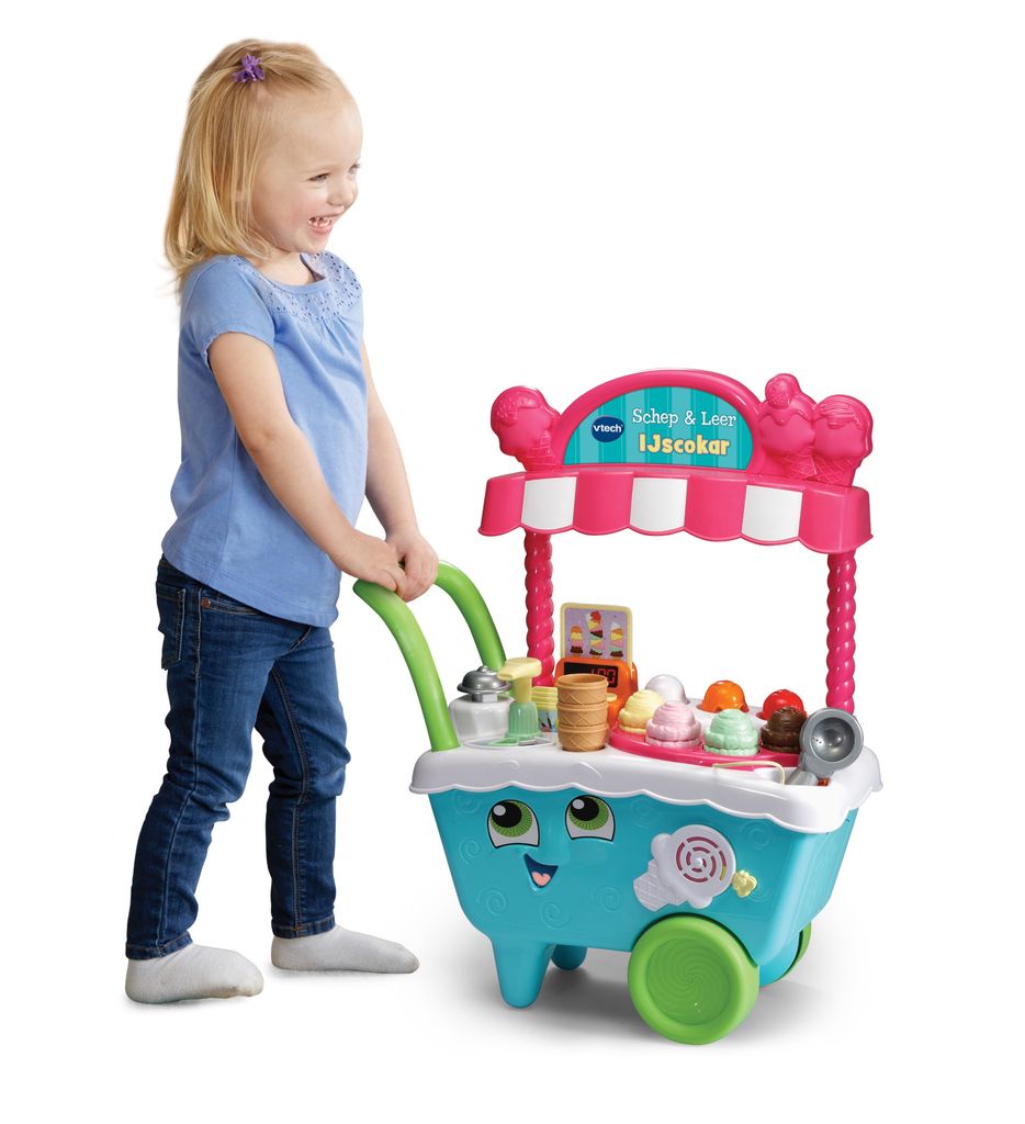 A young girl is playing with a VTech Scoop & Learn Eiswagen (ice cream cart) toy.