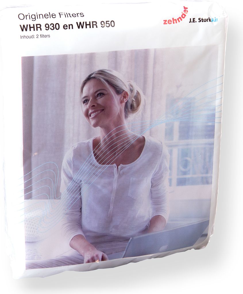 A woman is sitting on a bed with a laptop, with packaging for air filters in the foreground.