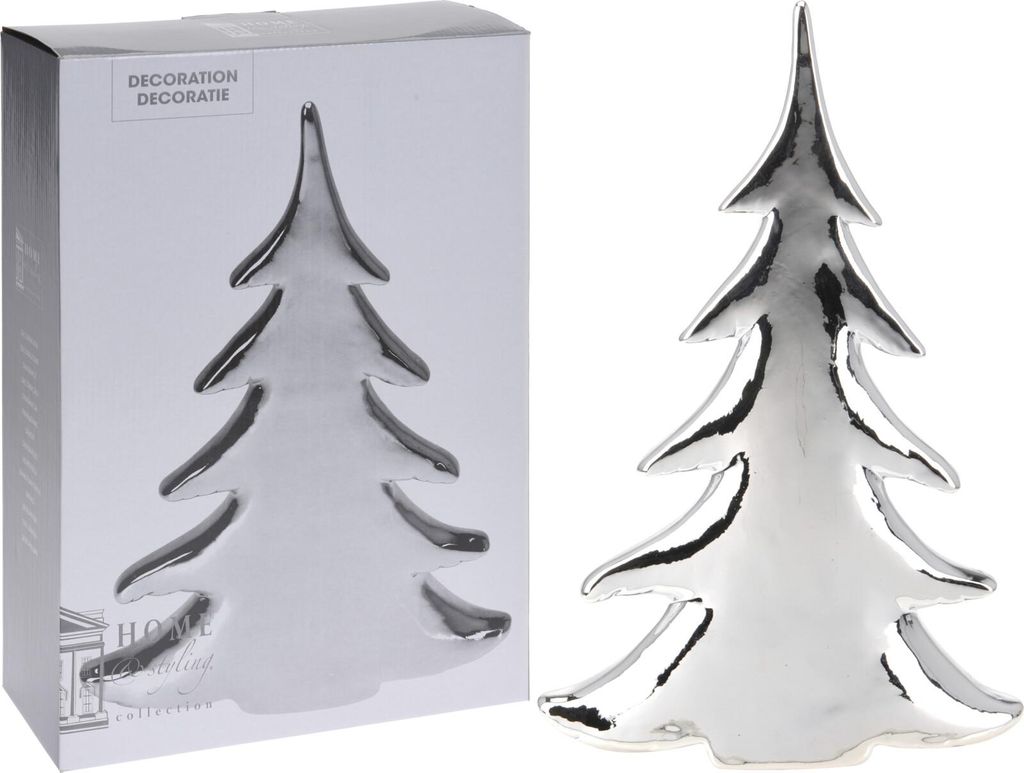A silver Christmas tree decoration is shown next to its packaging.