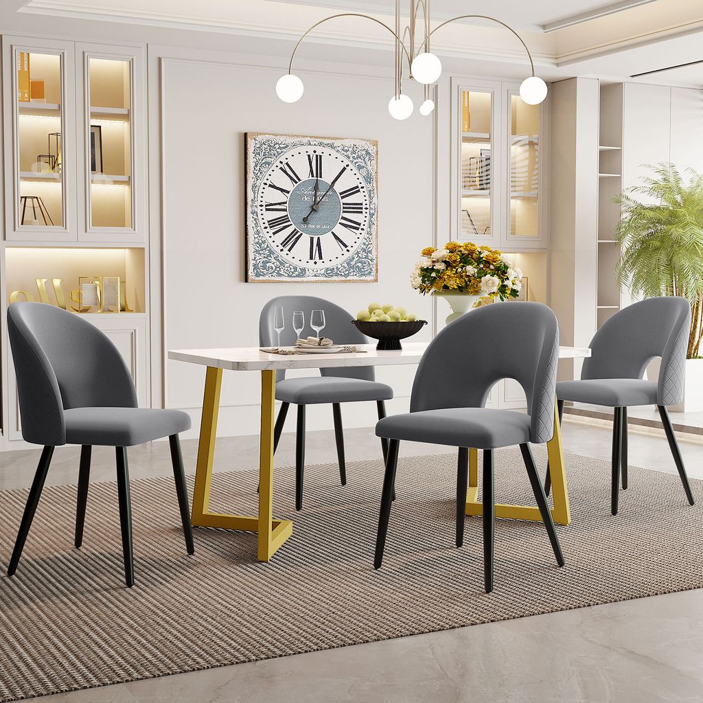 A dining room set with a rectangular table and four chairs, decorated with a large clock and flowers.