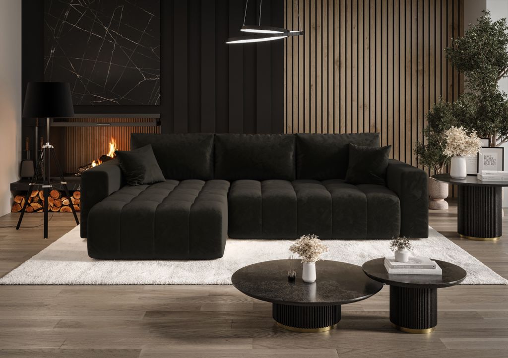 A modern living room with a black sectional sofa, fireplace, and wooden wall paneling.