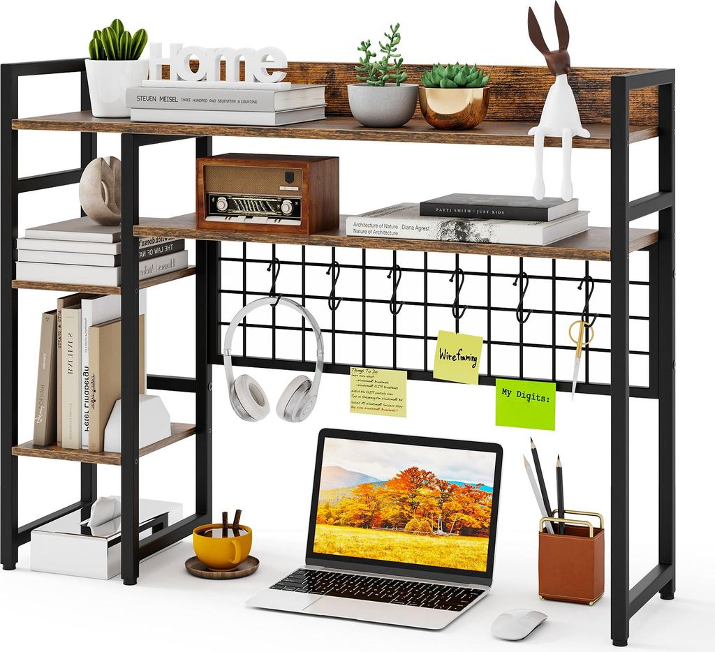 A desk shelf unit with various items on it, including a laptop, headphones, books, and decorative objects.