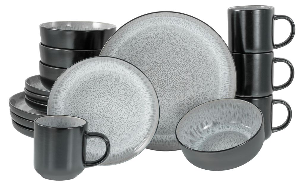 A collection of stoneware dinnerware, including plates, bowls, and mugs, arranged on a white background.