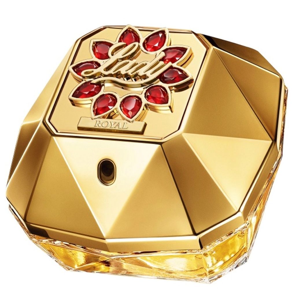 A close-up studio shot of a golden perfume bottle with red gem accents.