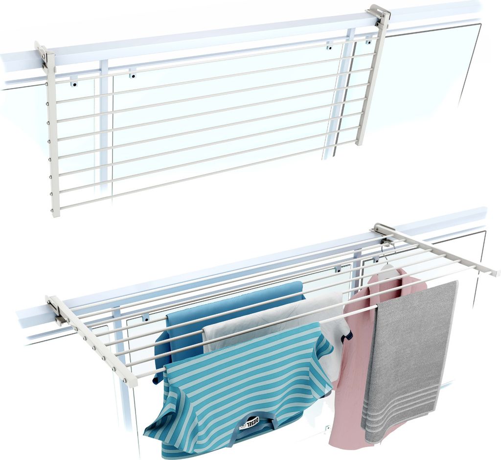 A white drying rack mounted on a balcony railing, with clothes hanging on it.