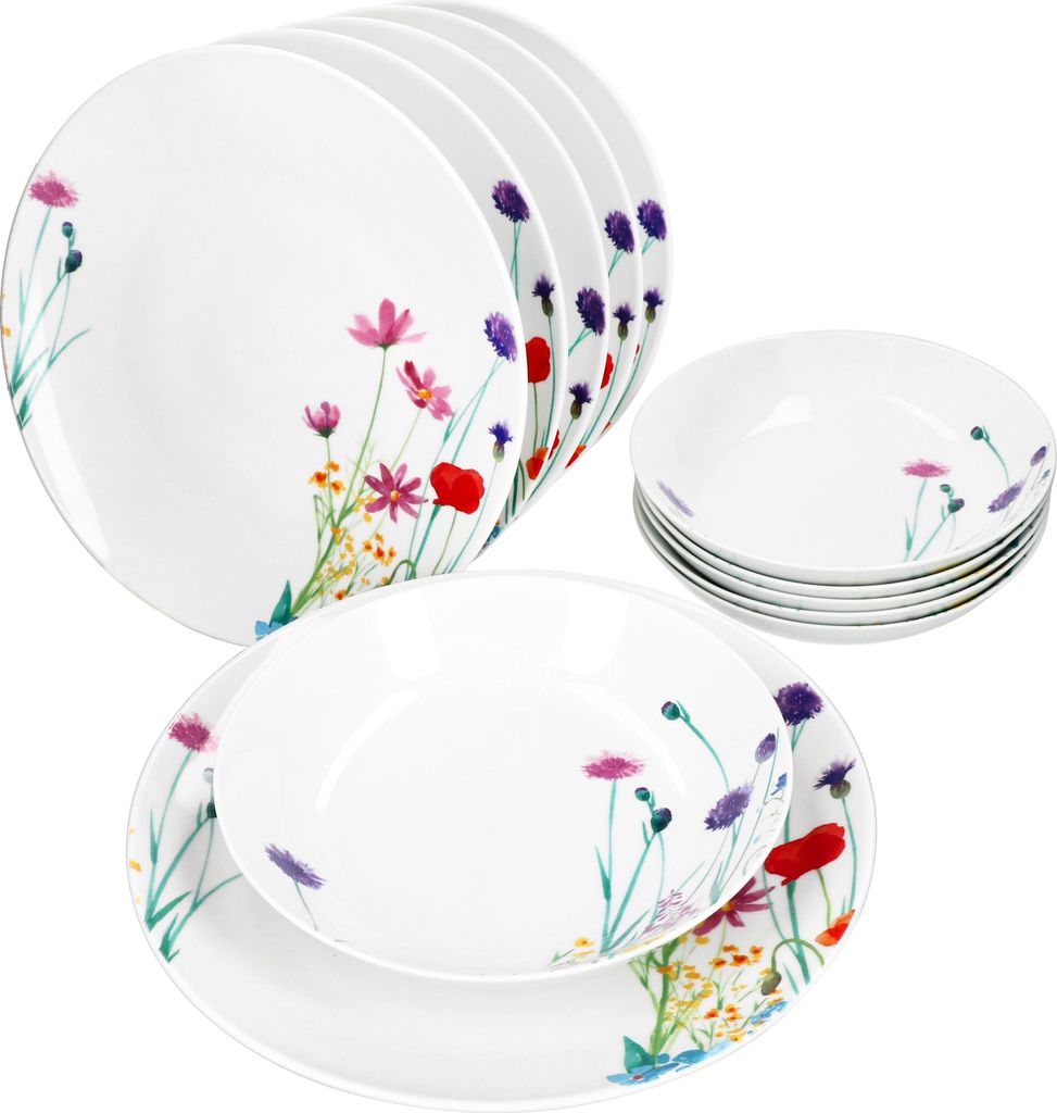 A set of white porcelain plates and bowls decorated with a floral pattern.