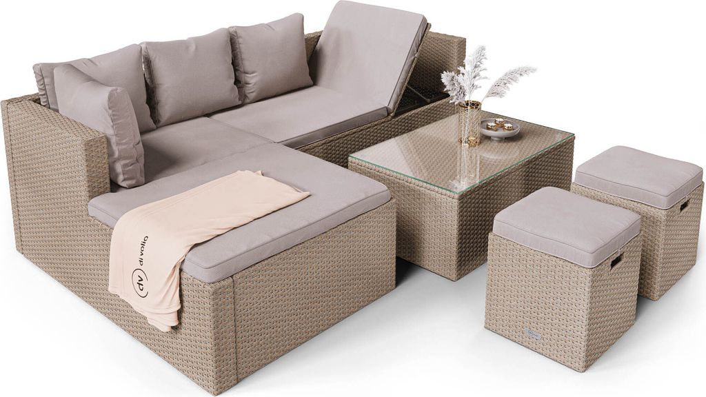 A beige rattan sectional sofa with a glass-topped coffee table and two ottomans, set against a white background.