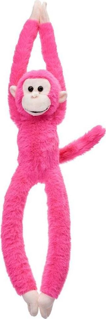 A pink plush monkey toy hanging by its arms against a white background.
