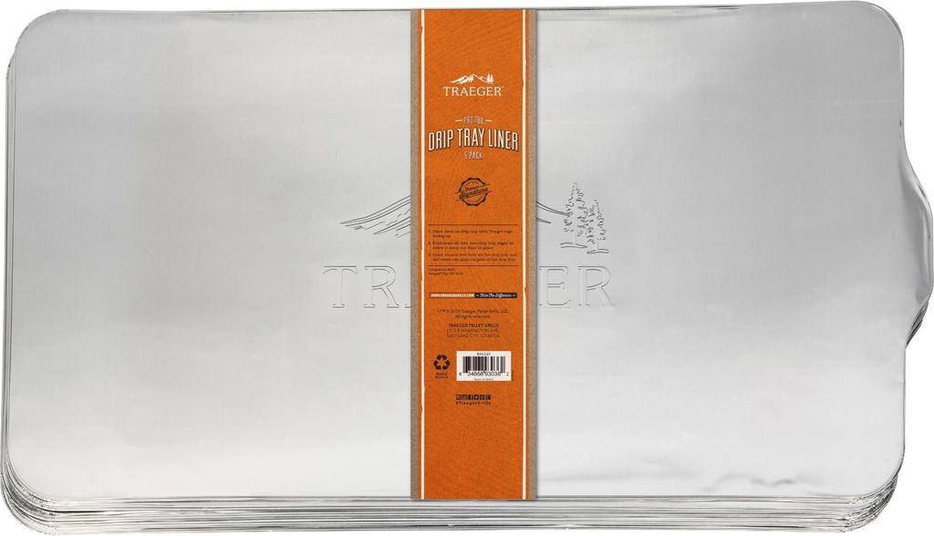 A stack of silver drip tray liners with an orange label in the center.