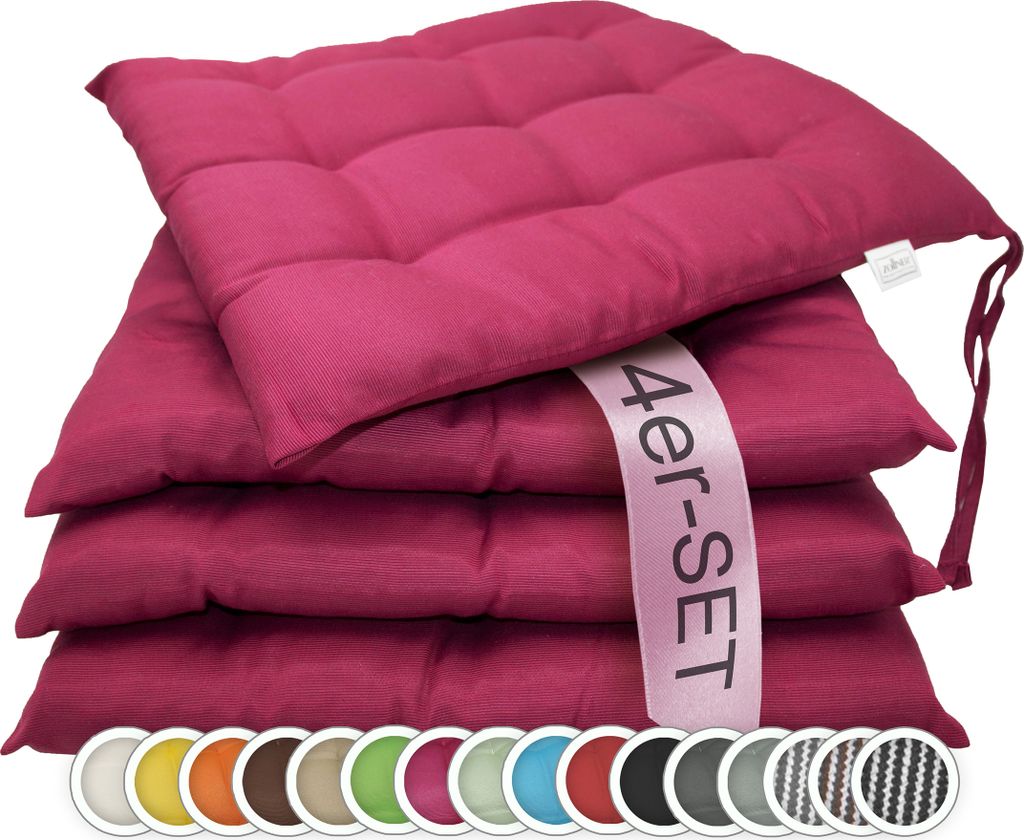 A stack of four fuchsia seat cushions.