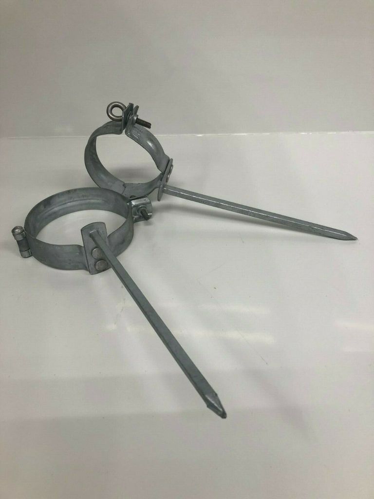 Two metal pipe clamps with spikes are shown on a white background.