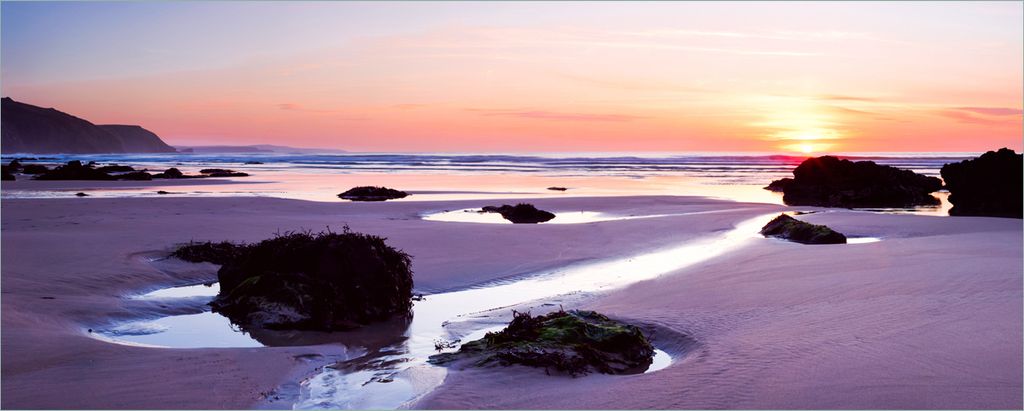 Wallario Poster - Sonnenuntergang am einsamen Strand, Kunstdruck Größe: 80 x 200 cm