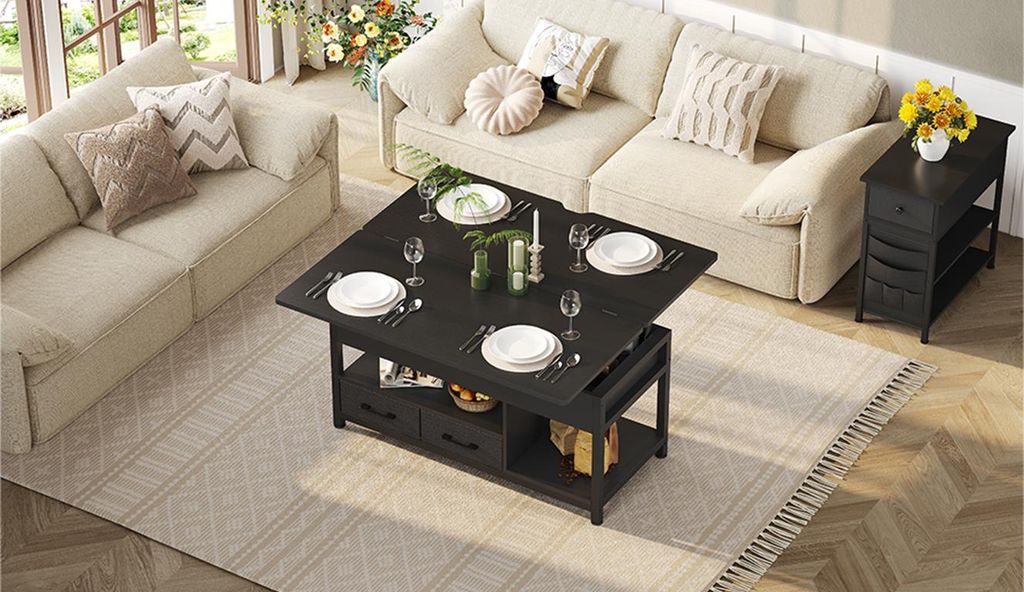 A living room scene with two sofas and a coffee table set for a meal.