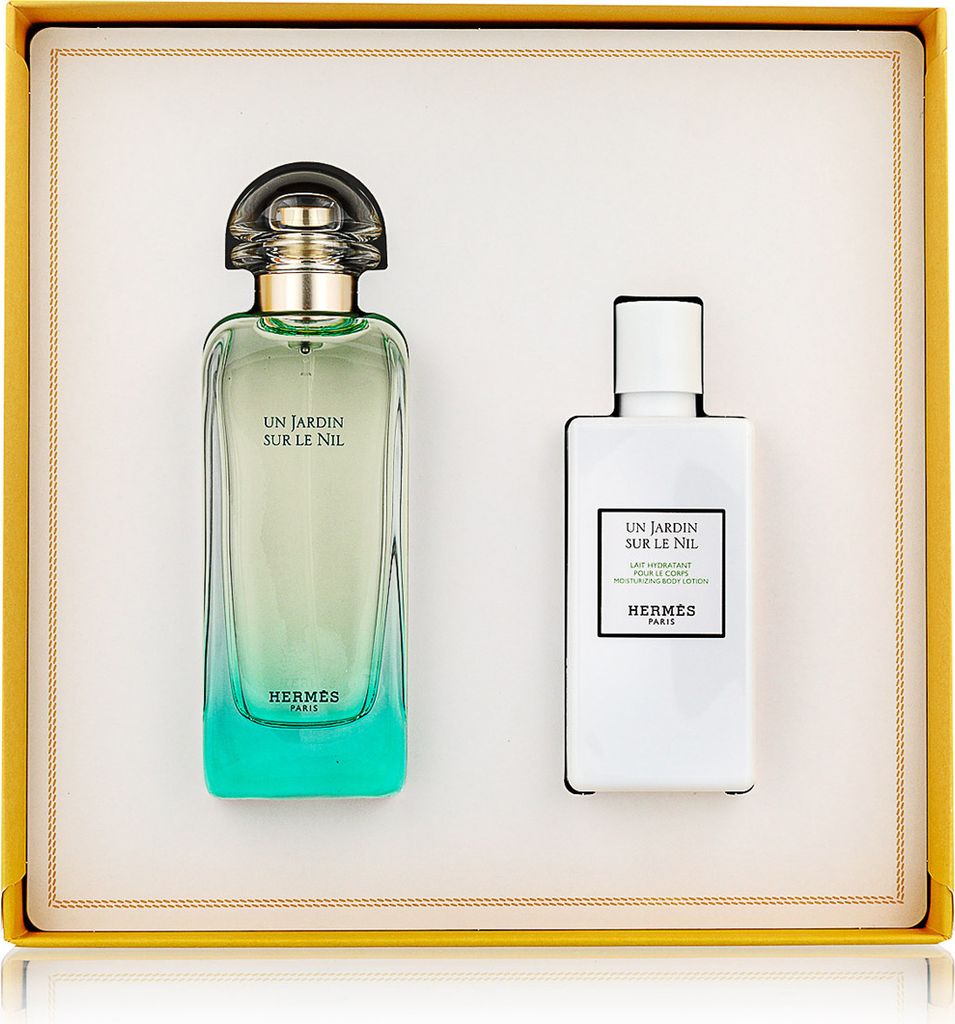 A gift set of two Hermès fragrance products, a perfume bottle and a lotion bottle, are displayed in a yellow box.